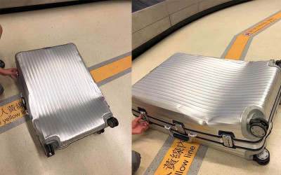 下飛機領行李時   驚見自己的名牌行李箱「完全變形」  航空公司竟回：難免的狀況，無法賠償